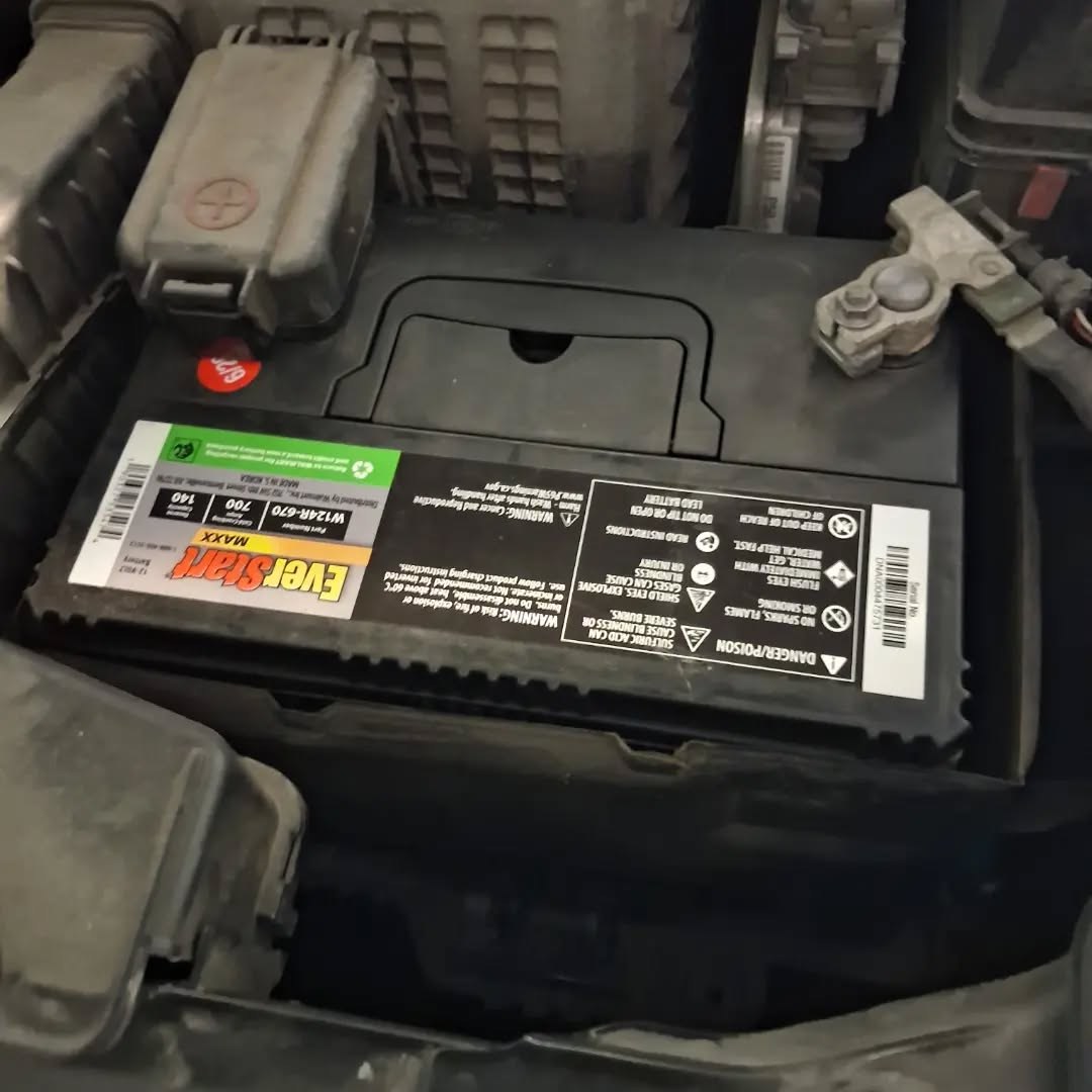 Freshly installed premium car battery secured in an engine bay