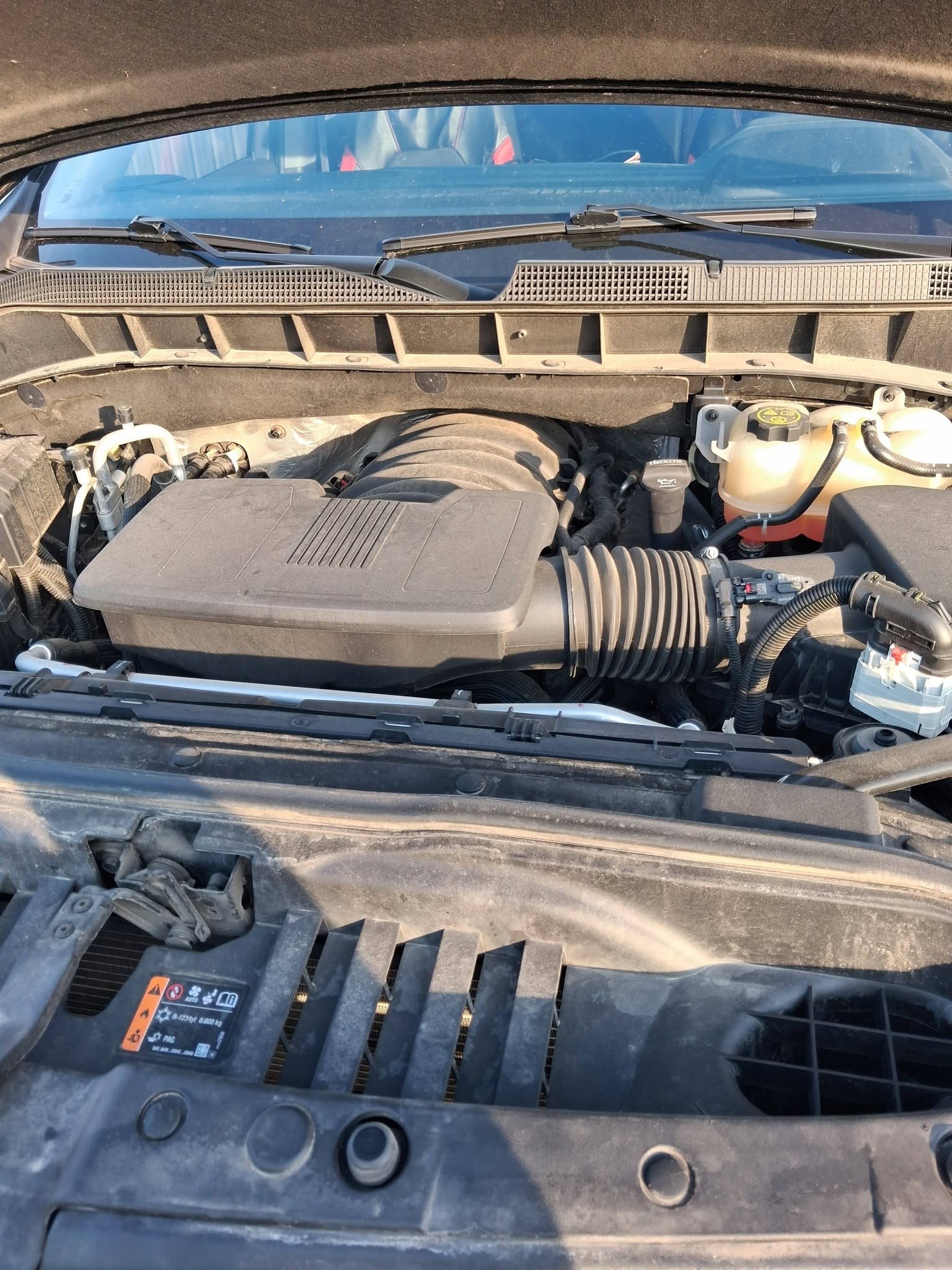 Chevy Silverado 1500 engine bay opened up for an on-site oil change