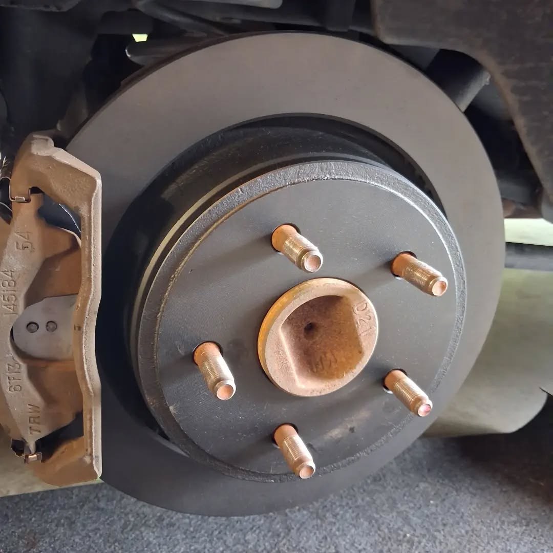 New rear brake rotor and caliper bracket mounted on a pickup hub