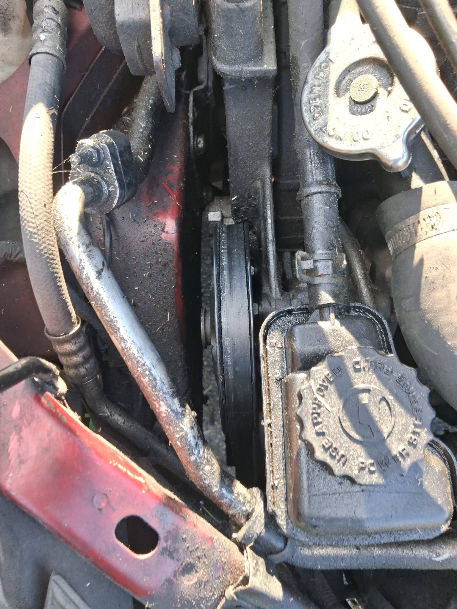 Serpentine belt and pulleys on the side of an engine