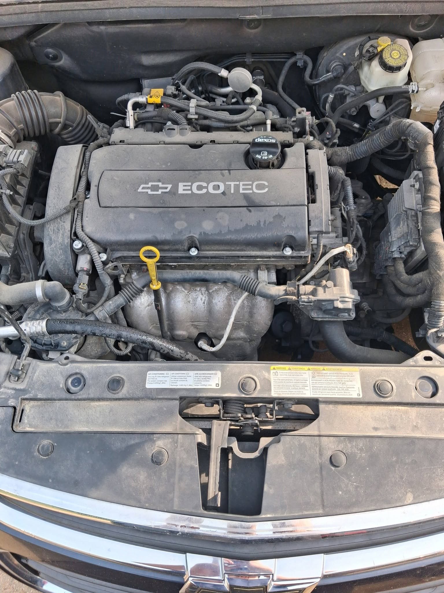 Chevy Cruze Ecotec engine bay open for an on-site oil change