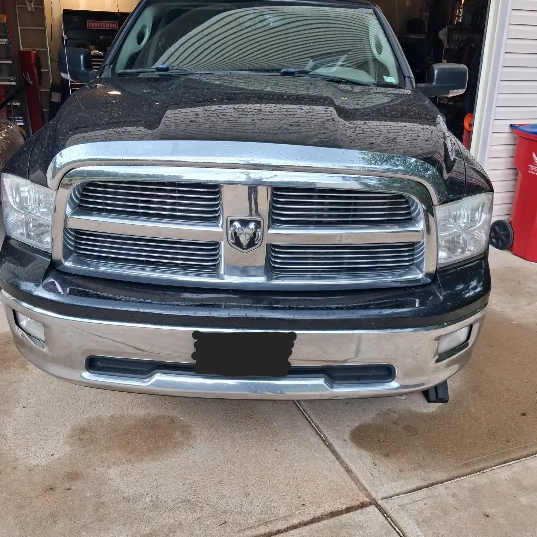 Black Ram 1500 pickup parked in a home garage after rear brake service